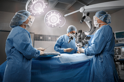 Physician performing surgery in operating room