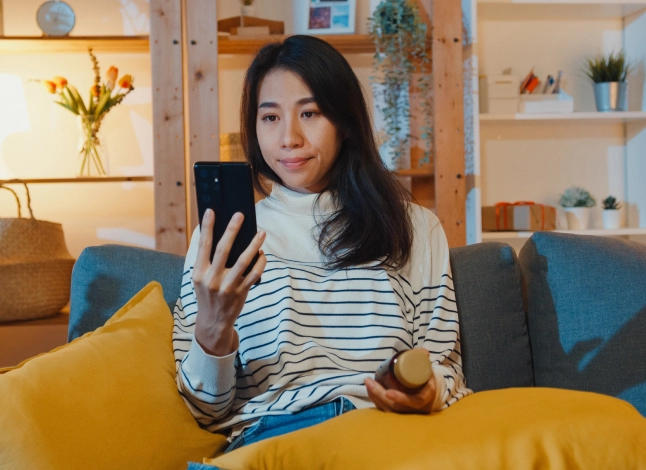 Two adults sitting and two children sitting in between the adults. Mountains in background.